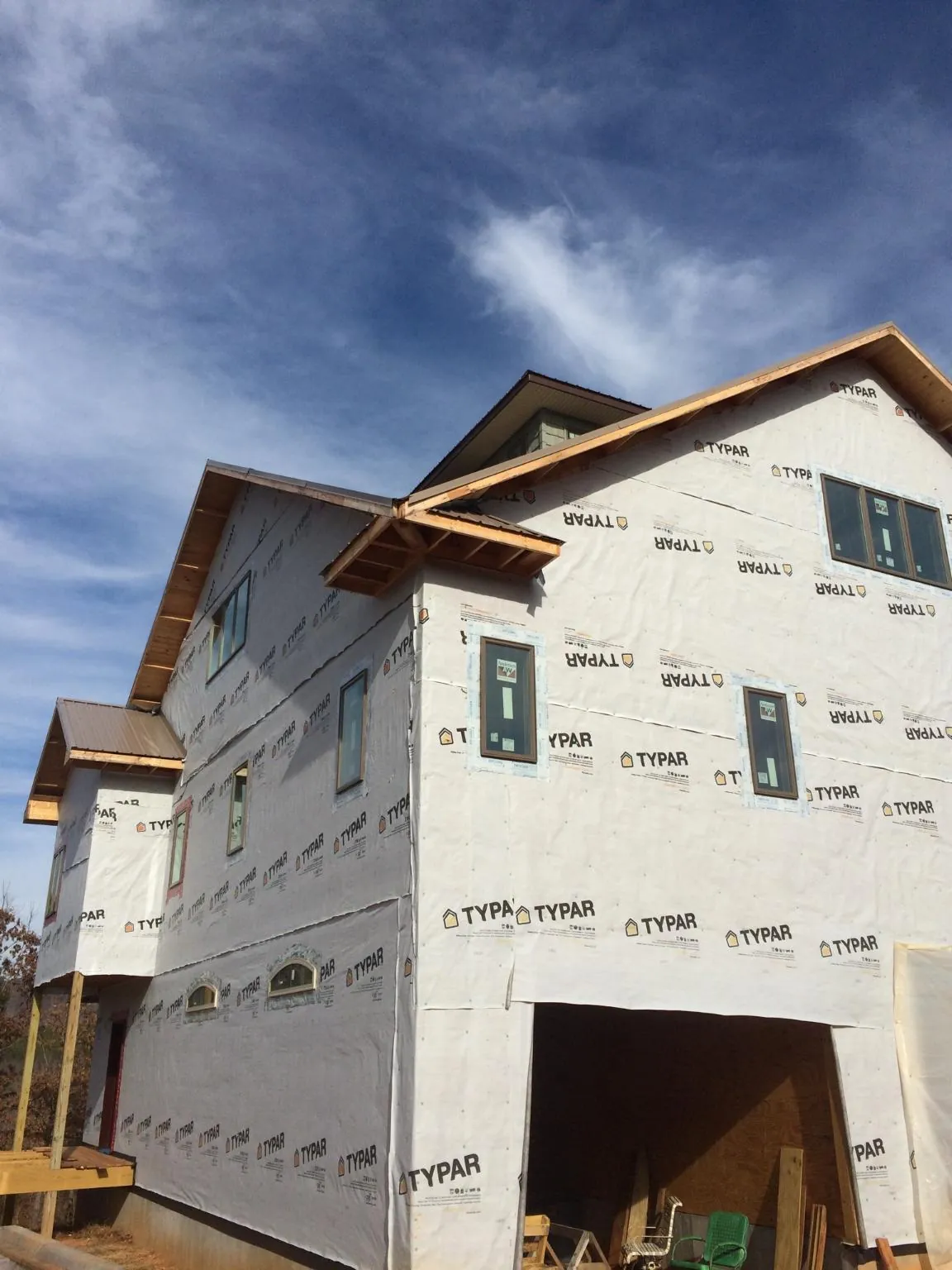 Stick built house wrapped in Typar with new roof framing and dormers in Cypress Inn